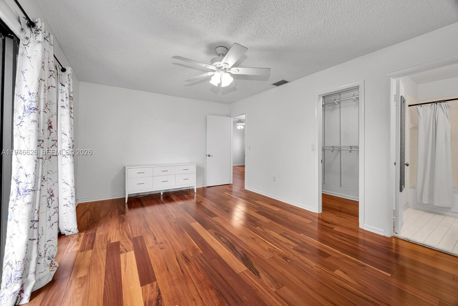 13121 Southwest 95th Avenue Miami, FL 33176 - Photo 12 of 41 a view of empty room with wooden floor and fan
