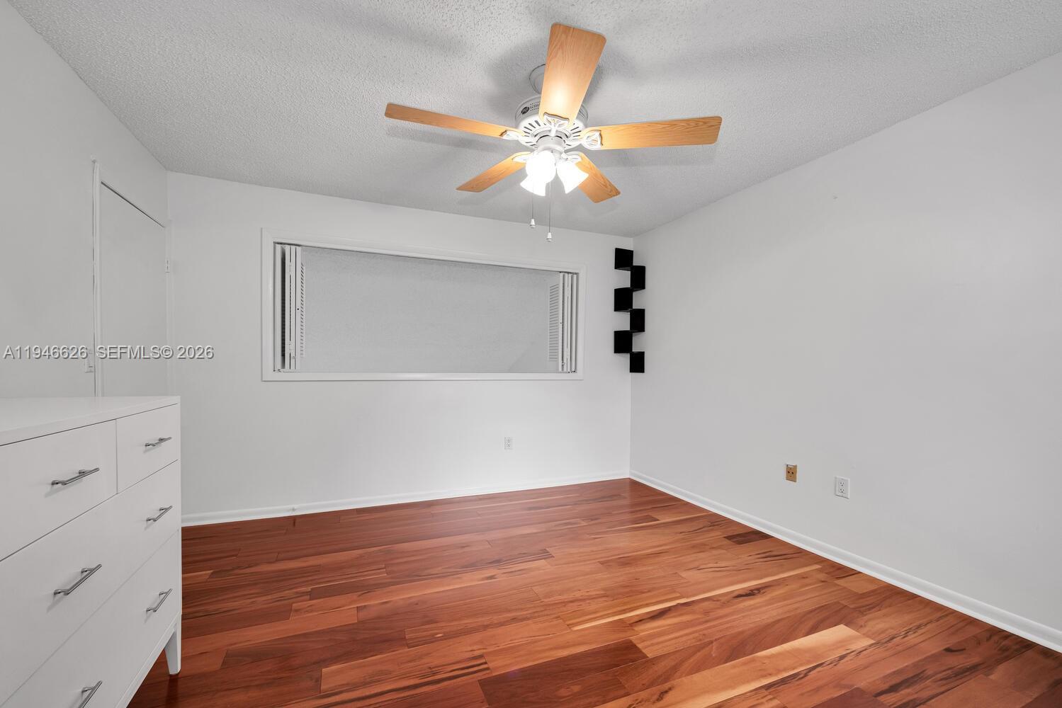 13121 Southwest 95th Avenue Miami, FL 33176 - Photo 17 of 41 a view of a room with wooden floor and fan