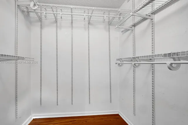 a view of a room with wooden floor