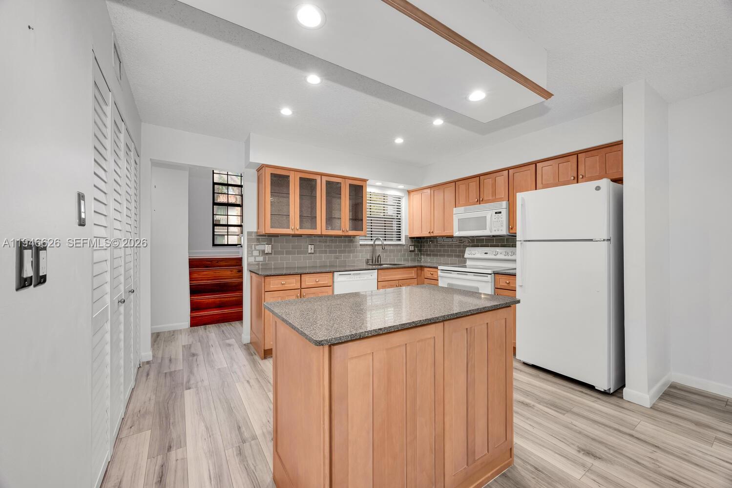 13121 Southwest 95th Avenue Miami, FL 33176 - Photo 3 of 41 a kitchen with stainless steel appliances granite countertop a refrigerator a stove and a wooden floors