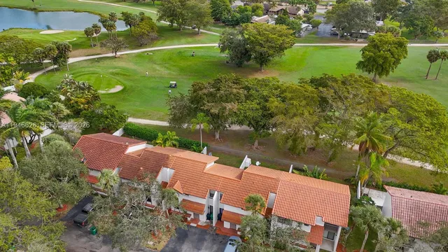 an aerial view of a house with a yard basket ball court and outdoor seating