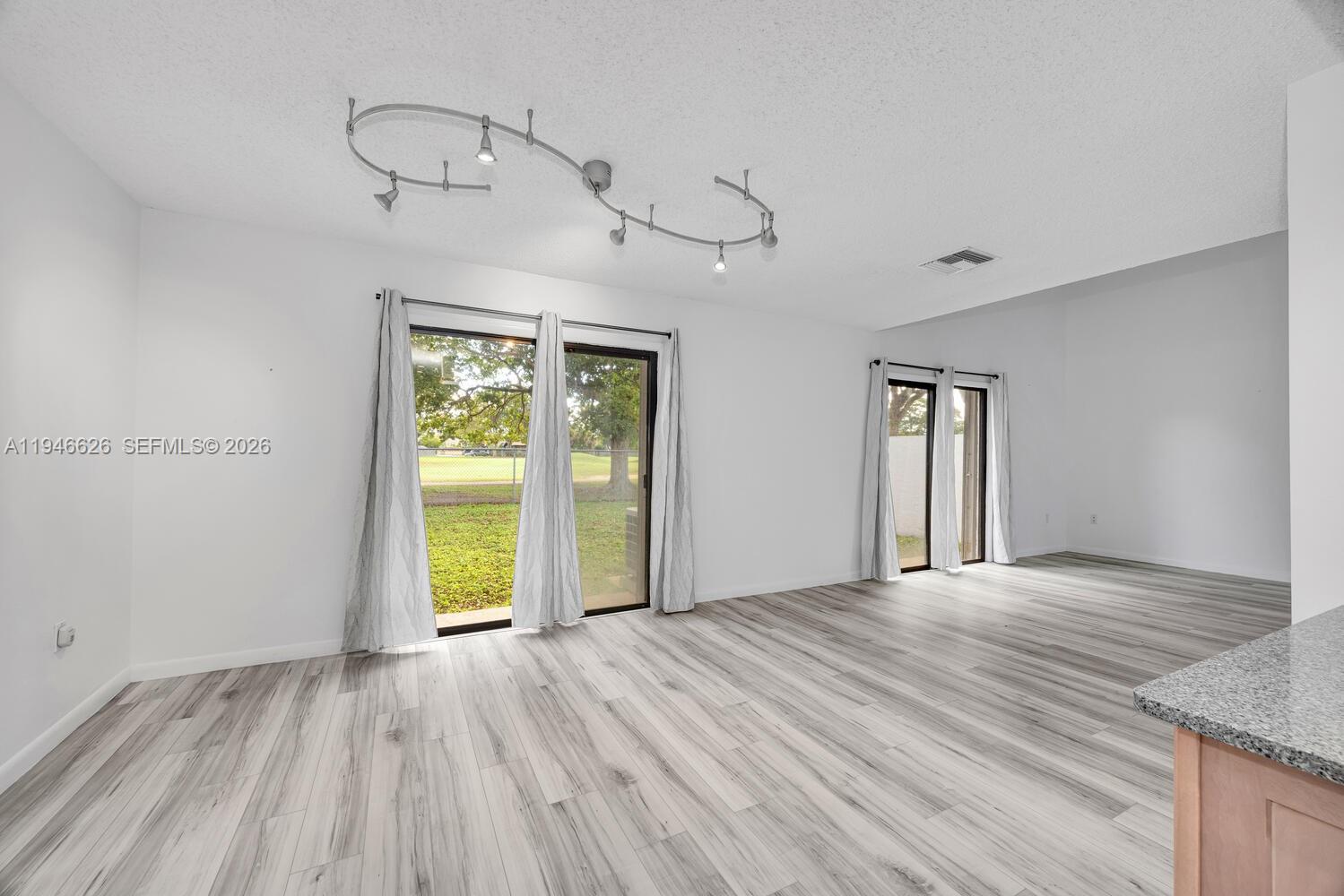 13121 Southwest 95th Avenue Miami, FL 33176 - Photo 8 of 41 a view of an empty room with a window and wooden floor