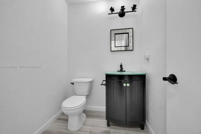 a bathroom with a toilet a sink and mirror