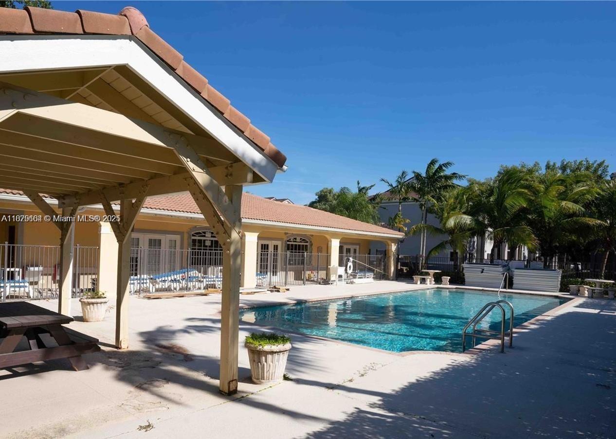 15430 Southwest 284th Street, Unit 6102 Homestead, FL 33033 - Photo 2 of 3 a patio with a yard table and chairs