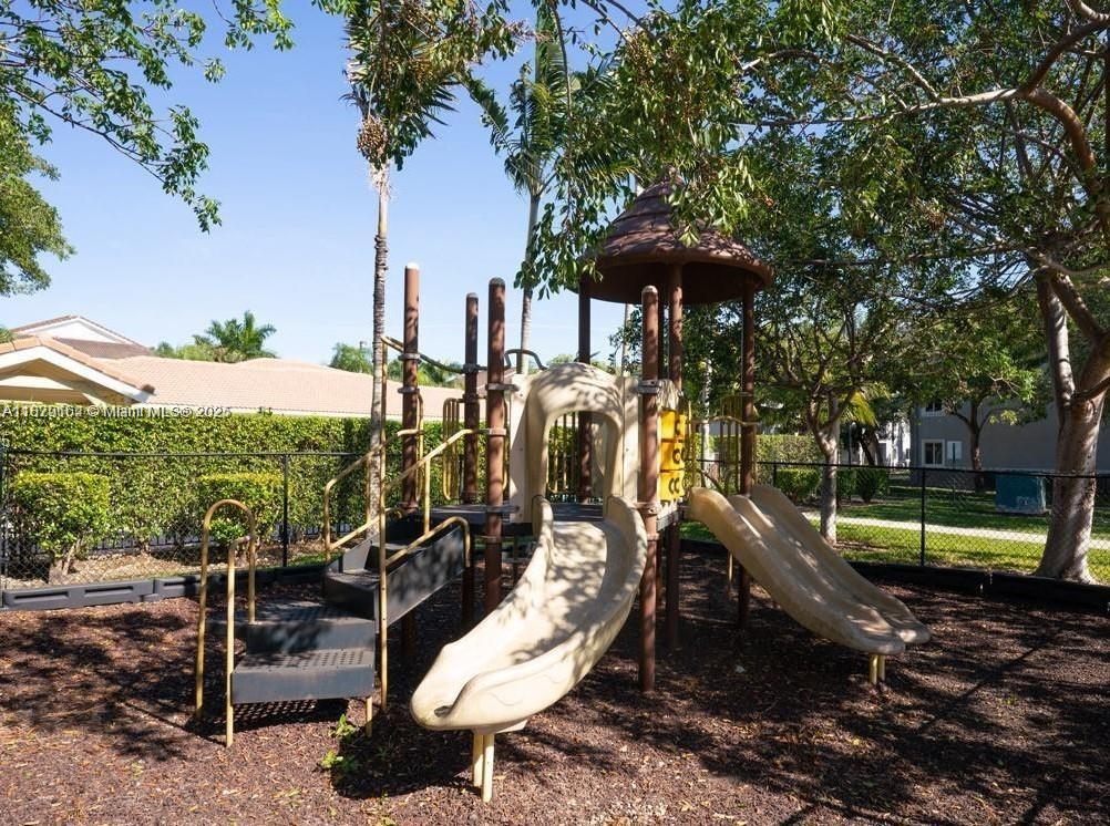 15430 Southwest 284th Street, Unit 6102 Homestead, FL 33033 - Photo 3 of 3 a view of a slide with chairs in patio