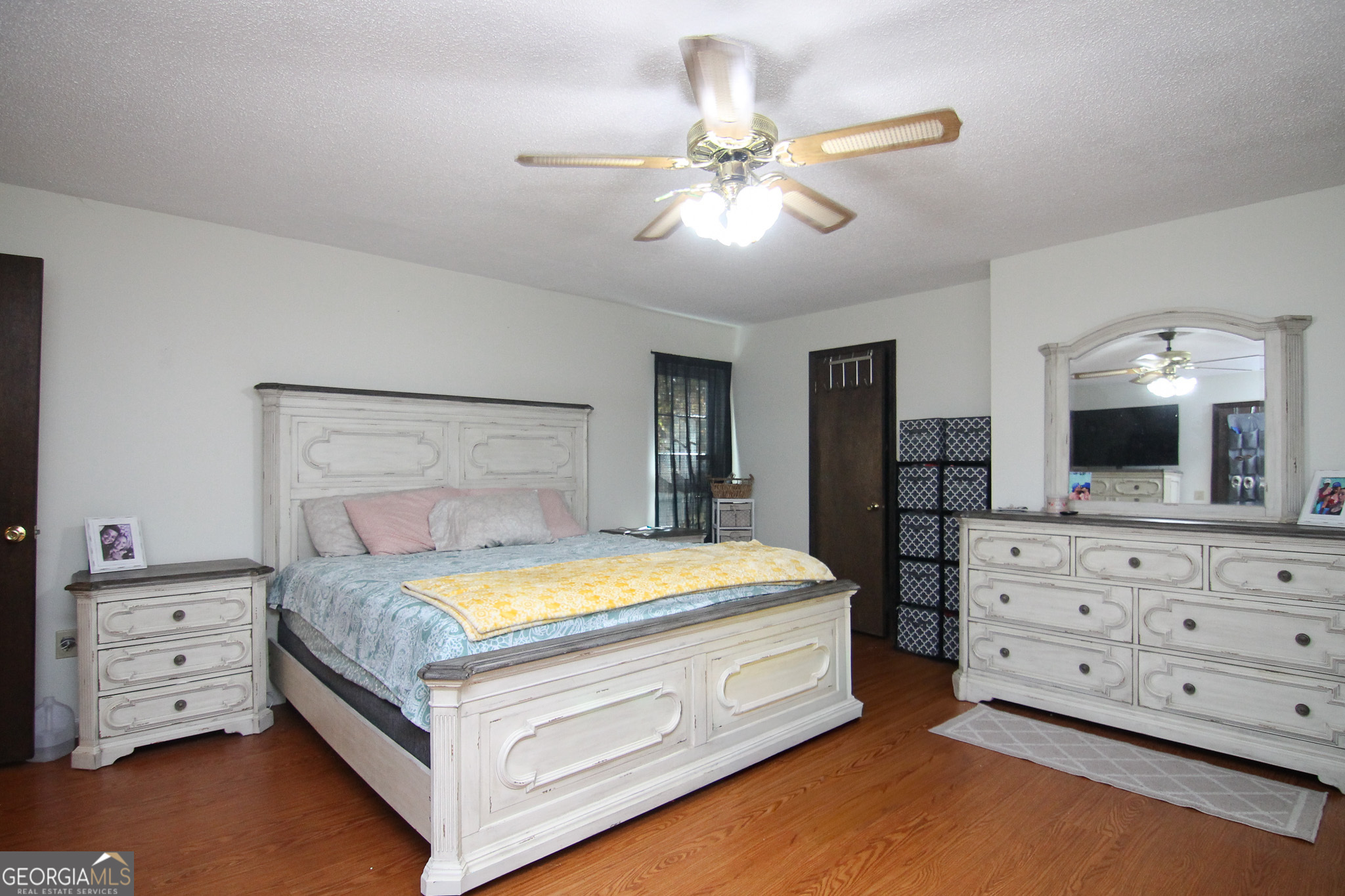 113 Pearce Drive Warner Robins, GA 31093 - Photo 17 of 27 a bedroom with a bed and a chandelier