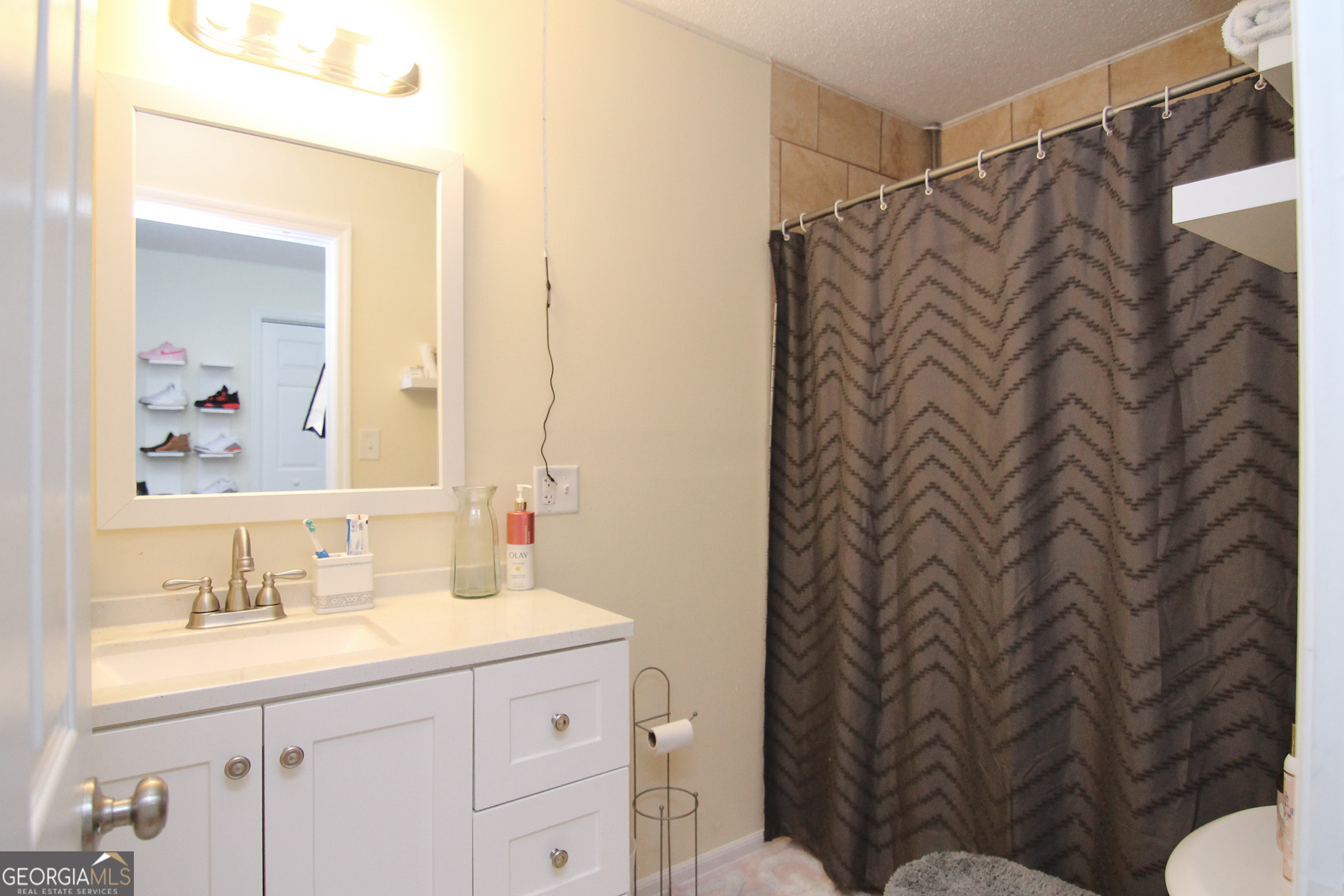 113 Pearce Drive Warner Robins, GA 31093 - Photo 23 of 27 a bathroom with a sink and mirror with toilet