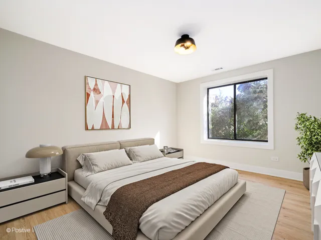 a bedroom with a bed and a painting on the wall