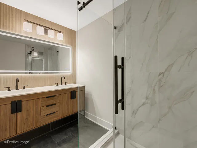 a bathroom with a double vanity sink and mirror