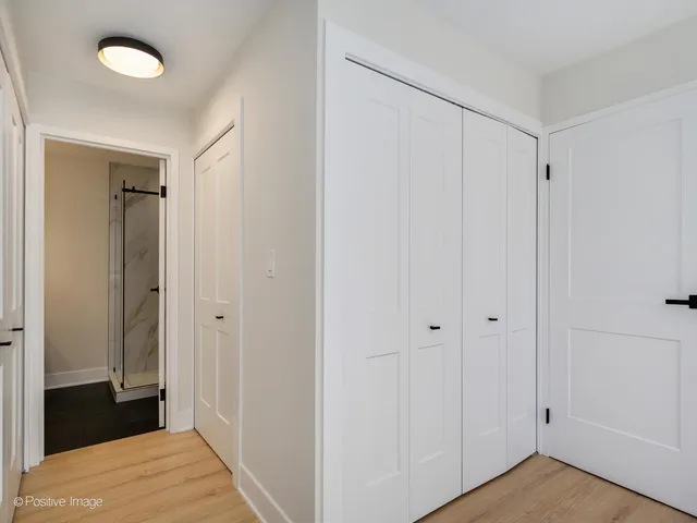 a view of a room with wooden floor and closet