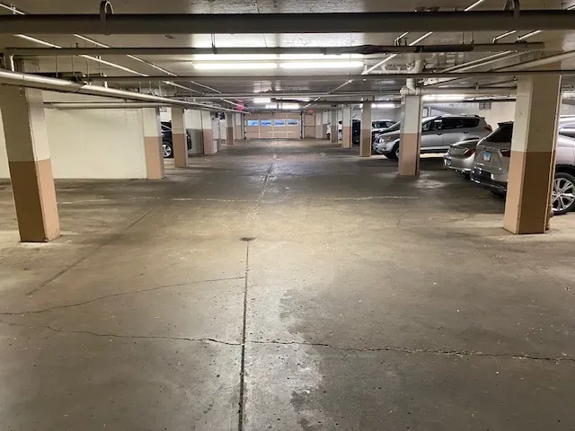 a view of parking garage with cars