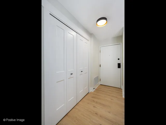 a view of a livingroom with wooden floor and closet