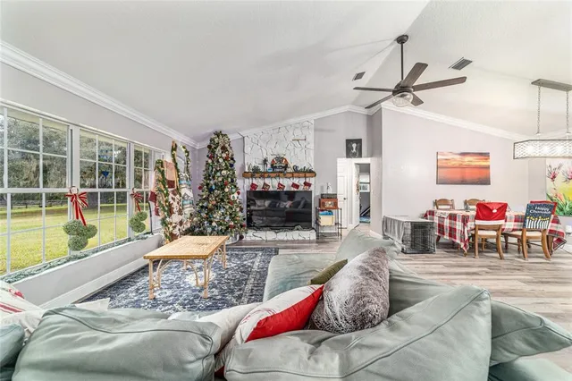 a living room with furniture and kitchen view