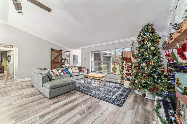 a very nice looking dining room with kitchen island furniture a chandelier a large window and kitchen view