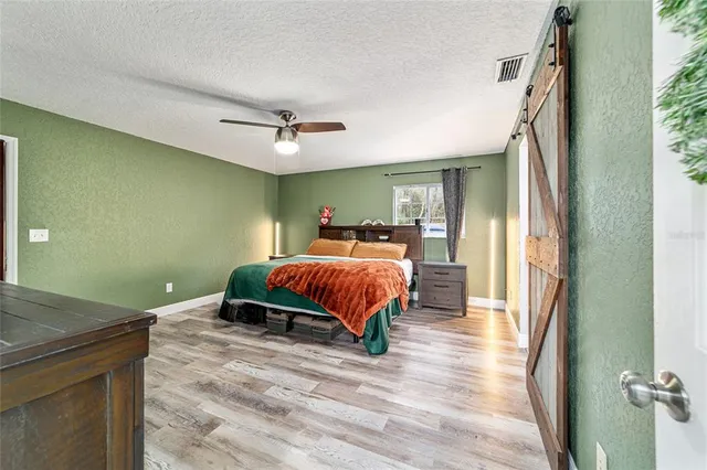 a bathroom with a granite countertop sink toilet mirror vanity and shower