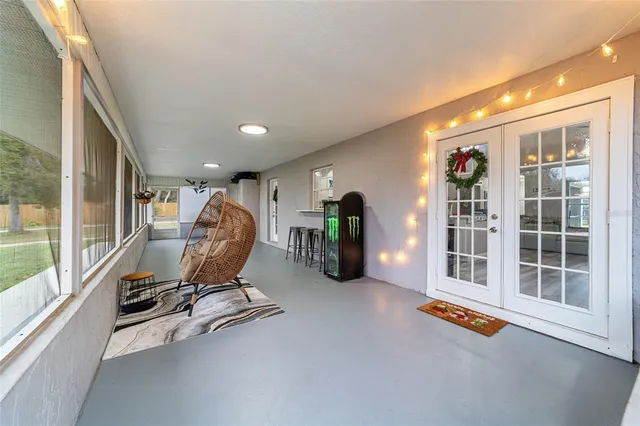 a view of a swimming pool with lawn chairs and a big yard