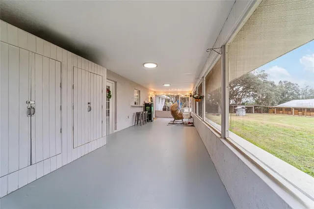 a view of a house with swimming pool and sitting area