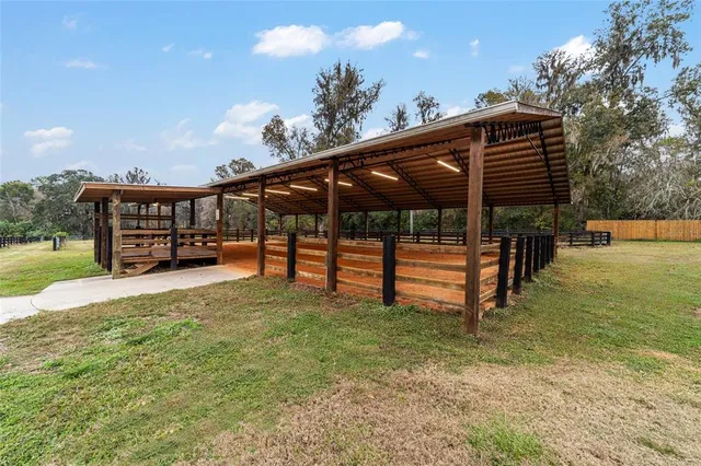 a view of a house with backyard and wooden fence