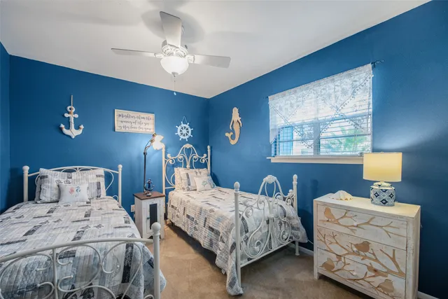a bedroom with two beds and a chandelier