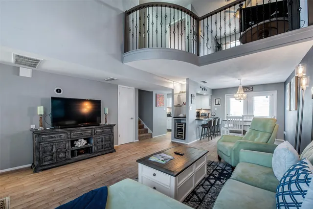a living room with furniture a flat screen tv and a floor to ceiling window