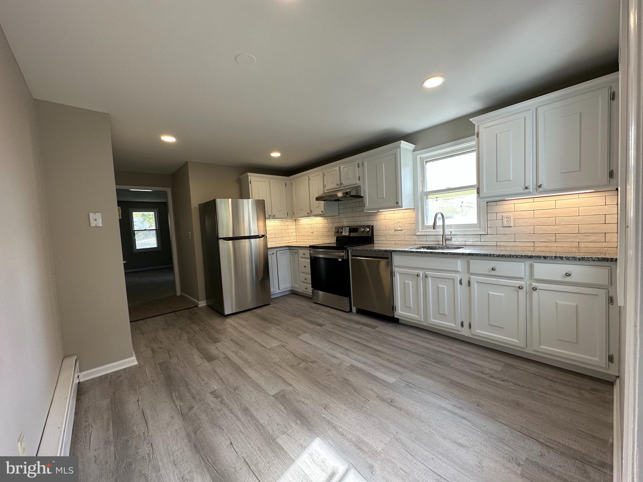 134 A Maple Avenue Dublin, PA 18917 - Photo 2 of 23 a kitchen with stainless steel appliances granite countertop a stove top oven a sink dishwasher and a refrigerator