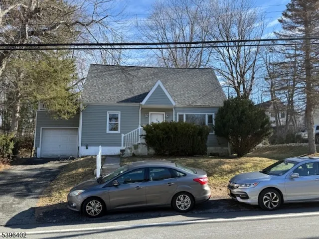 a view of a car parked front of a house