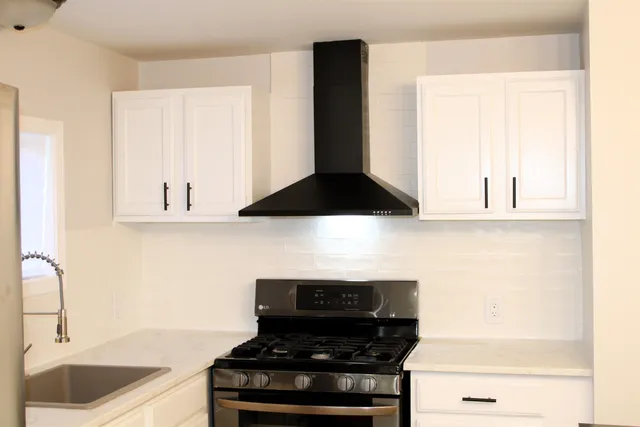 a kitchen with a stove and a sink