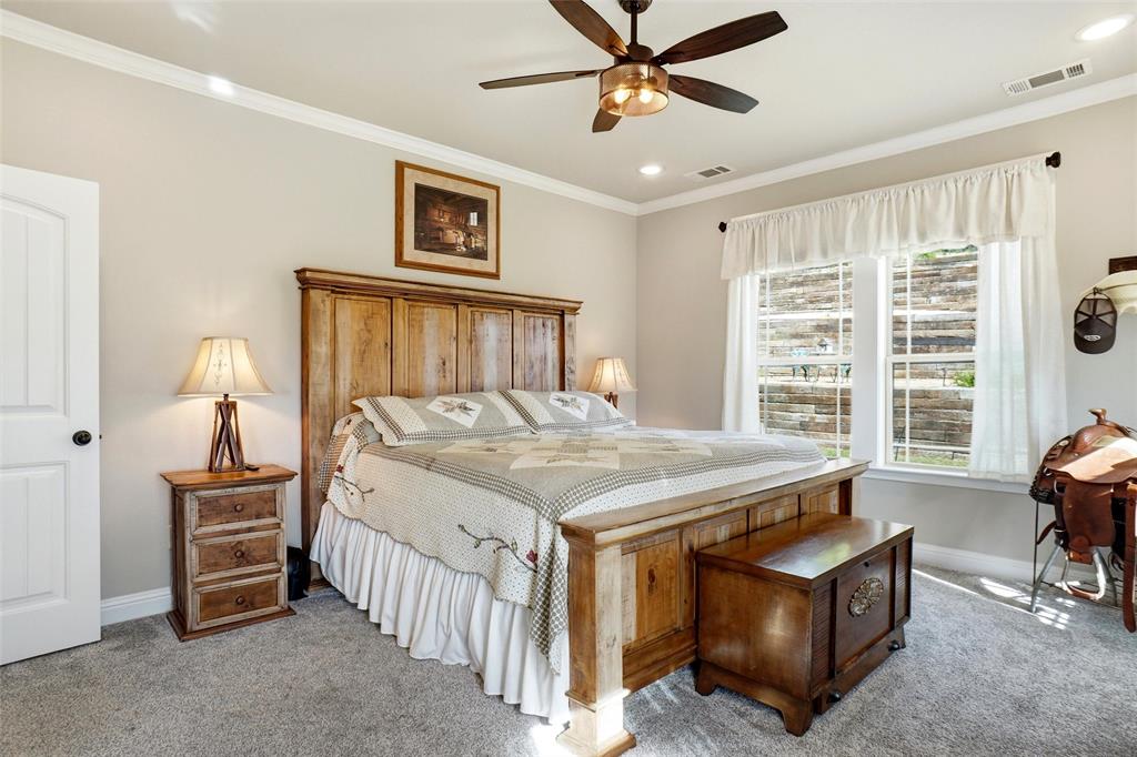 1024 Tex Lane Springtown, TX 76082 - Photo 20 of 40 a bed sitting in a spacious bedroom next to a window