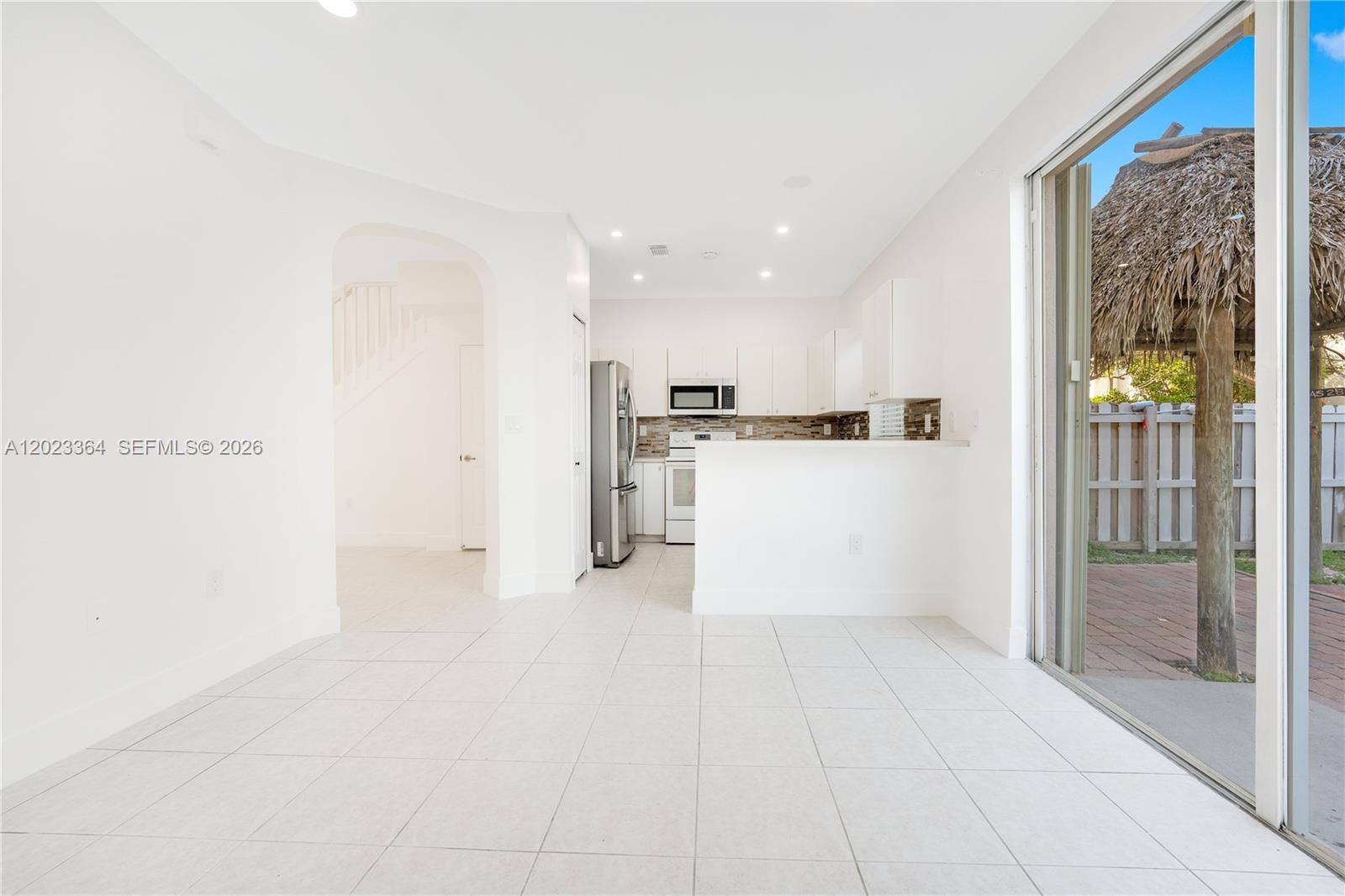 27433 Southwest 137th Court, Unit 1 Homestead, FL 33032 - Photo 7 of 28 a view of a kitchen with a sink and a refrigerator