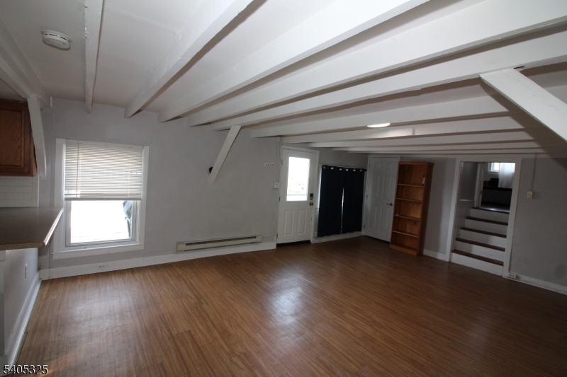 171 Stanton Road, Unit A Flemington, NJ 08822 - Photo 9 of 12 an empty room with wooden floor and windows