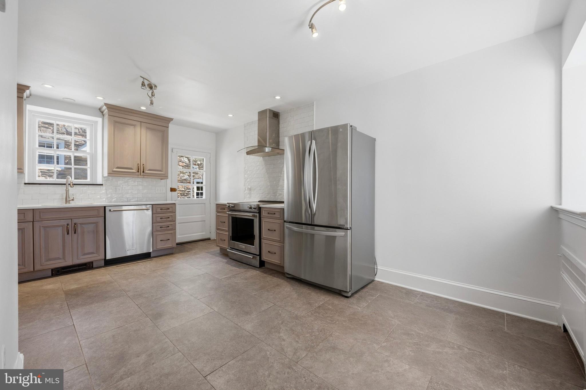 326 Winding Way Merion Station, PA 19066 - Photo 11 of 33 a kitchen with stainless steel appliances a refrigerator sink and cabinets