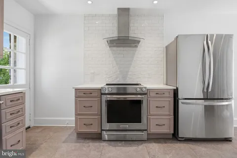 a kitchen with granite countertop a stove and a refrigerator