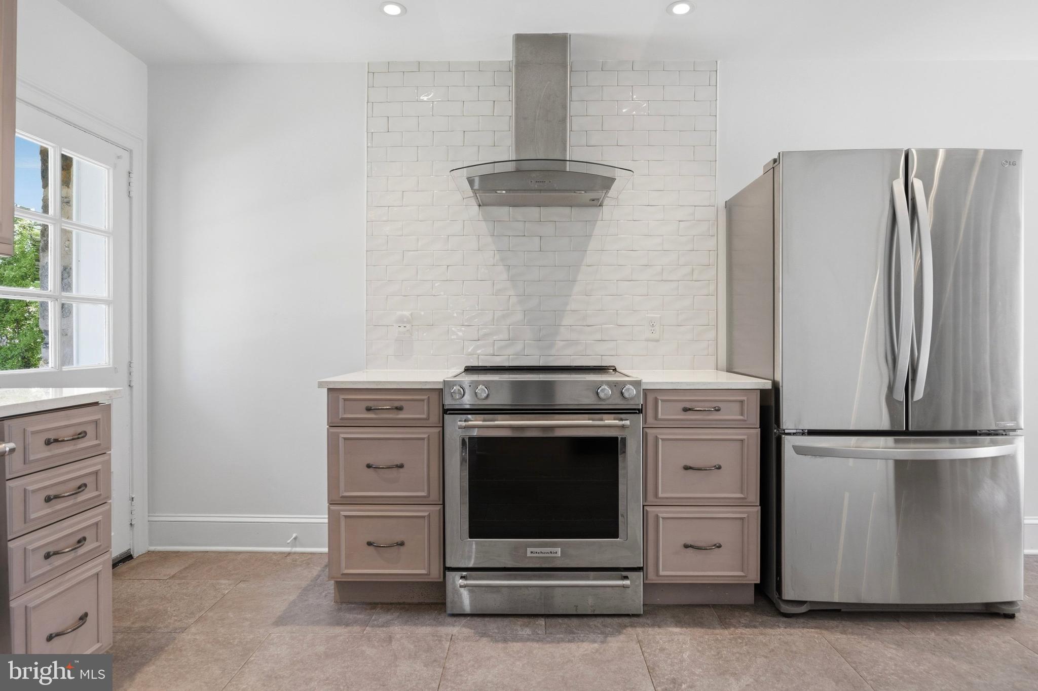 326 Winding Way Merion Station, PA 19066 - Photo 12 of 33 a kitchen with granite countertop a stove and a refrigerator