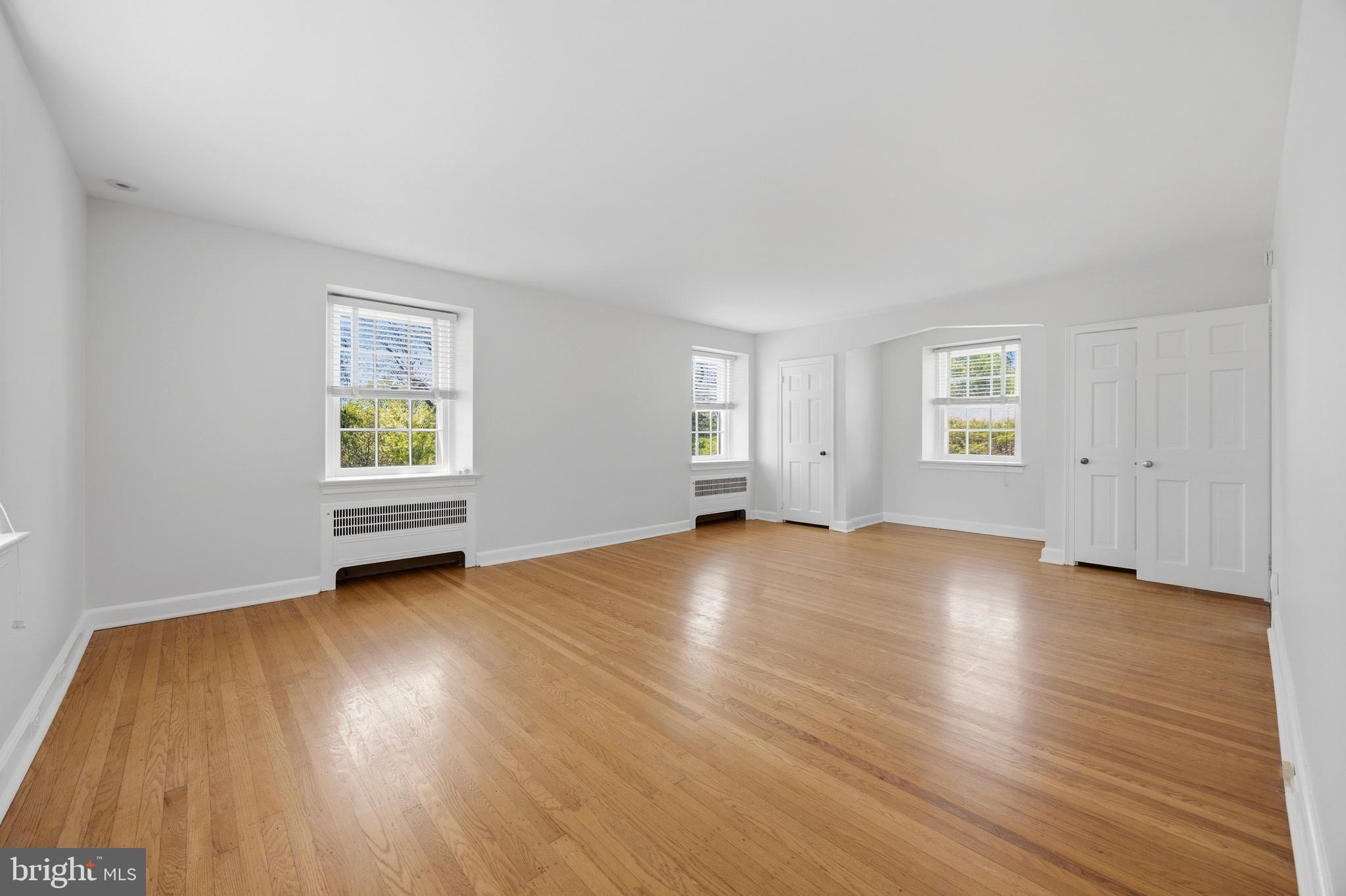 326 Winding Way Merion Station, PA 19066 - Photo 16 of 33 an empty room with wooden floor and windows