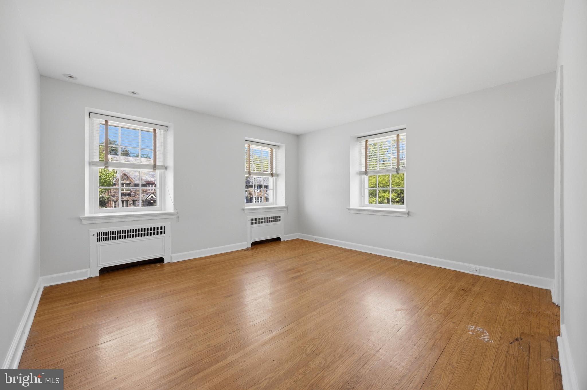 326 Winding Way Merion Station, PA 19066 - Photo 18 of 33 a view of an empty room with a window and wooden floor