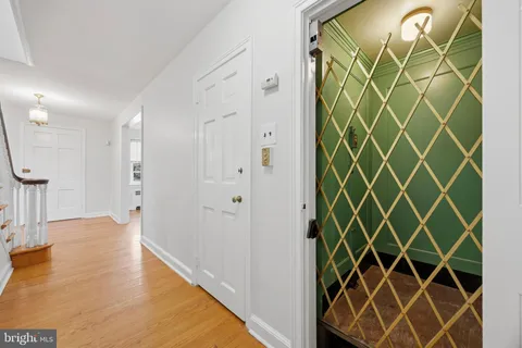 a view of empty room with wooden floor and door