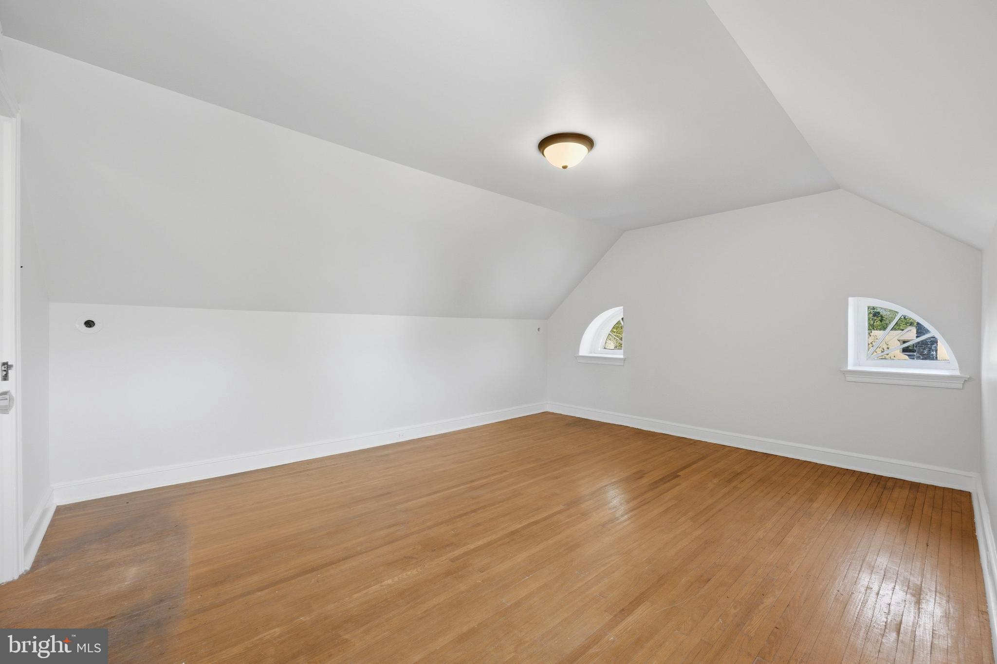 326 Winding Way Merion Station, PA 19066 - Photo 28 of 33 an empty room with wooden floor and windows