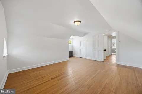 a view of room with wooden floor and windows