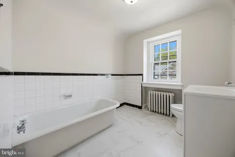 a bathroom with a bathtub and window