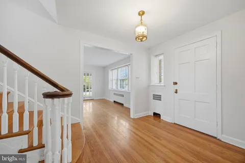 a view of entryway with wooden floor and stairs