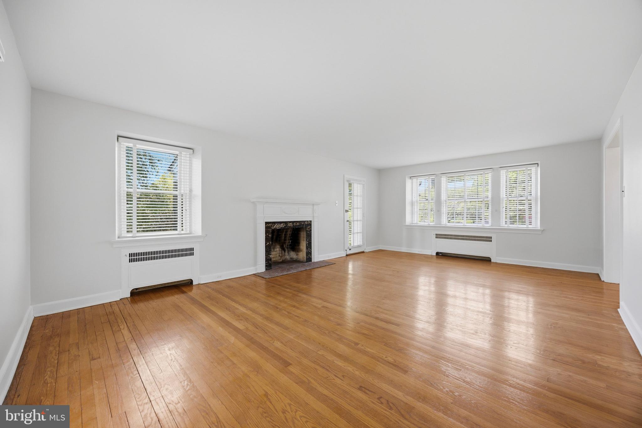 326 Winding Way Merion Station, PA 19066 - Photo 6 of 33 a view of empty room with wooden floor and fireplace