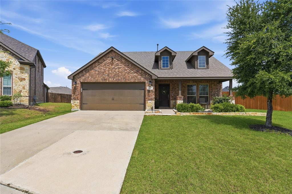 10101 Travis Road Little Elm, TX 75068 - Photo 1 of 26 a front view of a house with garden