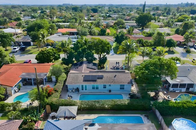 an aerial view of multiple houses with yard
