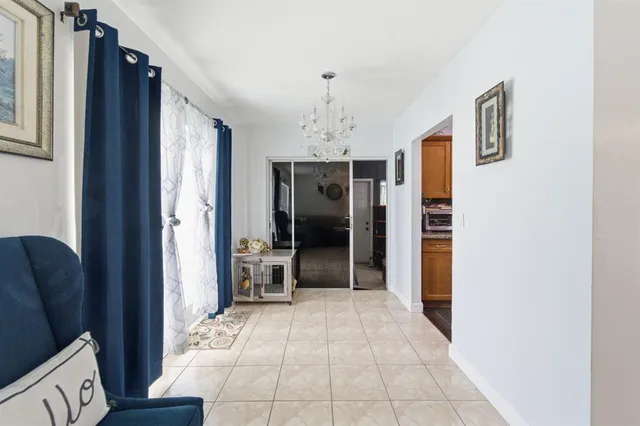 a view of a hallway with wooden floor and furniture