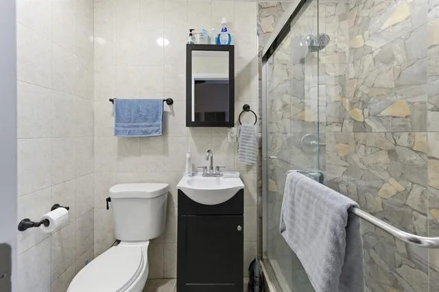 a bathroom with a toilet sink and mirror