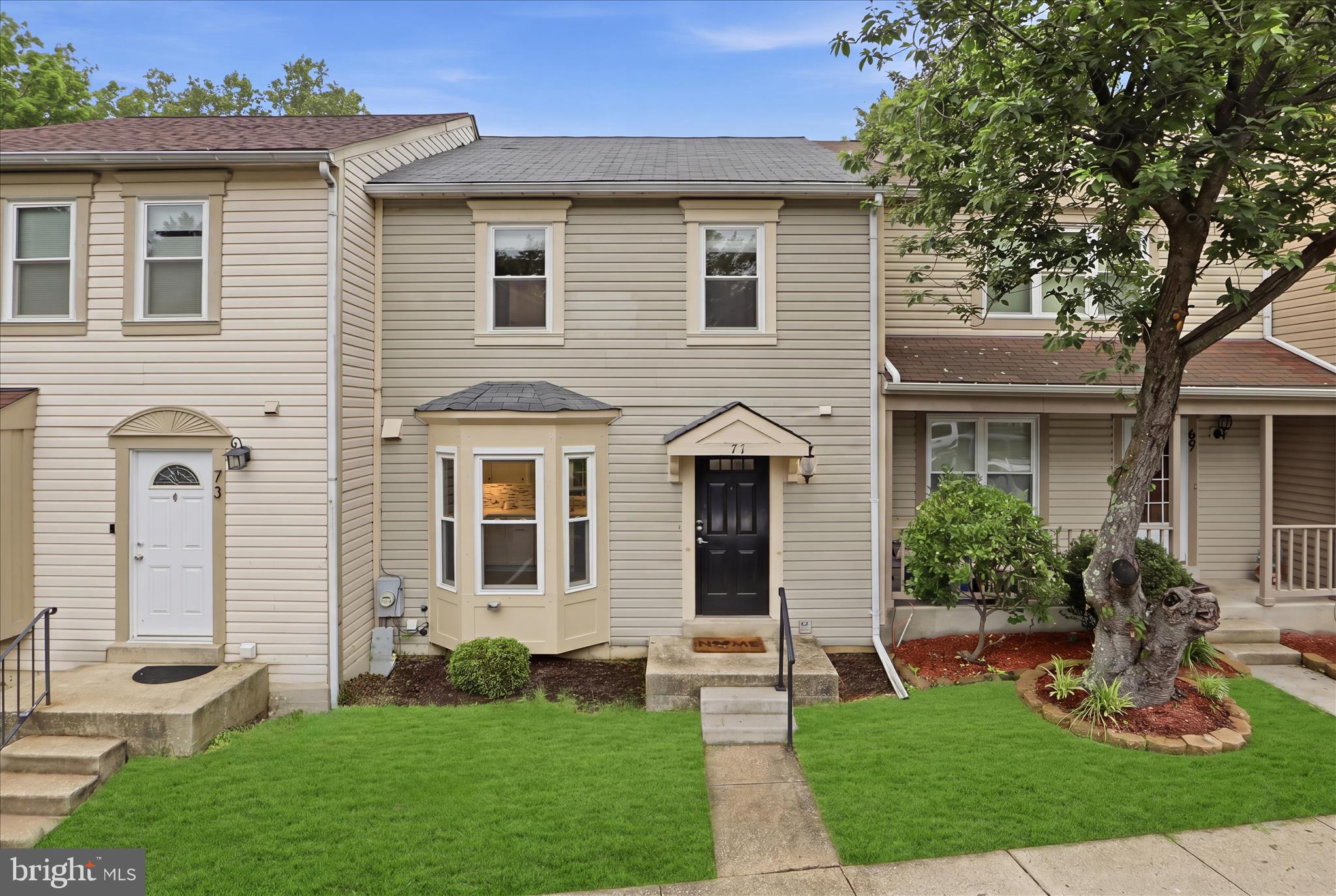 71 Kinsman View Circle Silver Spring, MD 20901 - Photo 37 of 42 a front view of a house with garden