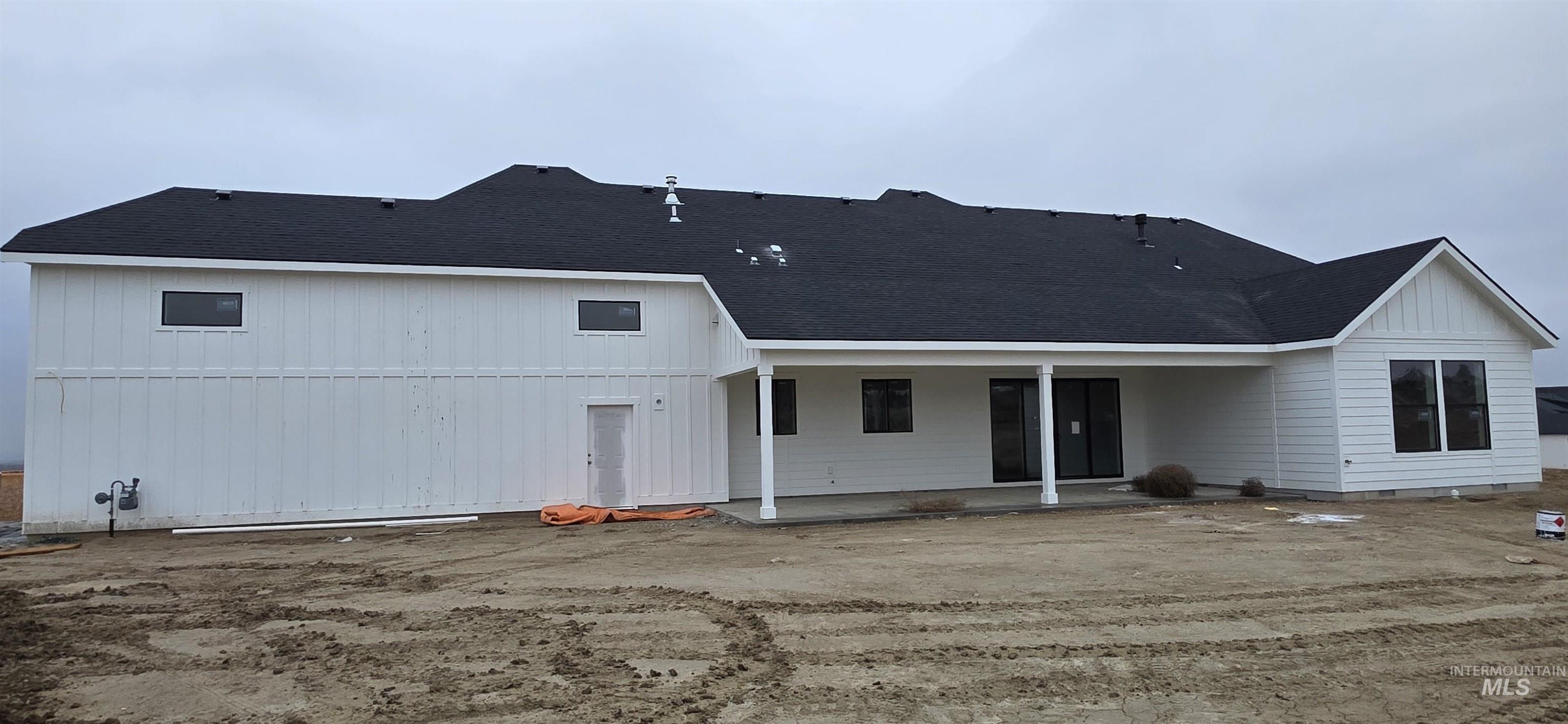 17244 Triple Crown Place Caldwell, ID 83607 - Photo 2 of 8 Back of property featuring a patio and roof with shingles