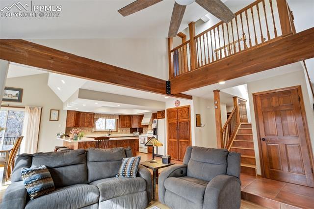 4385 Sandstone Road Monument, CO 80132 - Photo 30 of 50 Living room featuring stairway, high vaulted ceiling, recessed lighting, beamed ceiling, and a ceiling fan