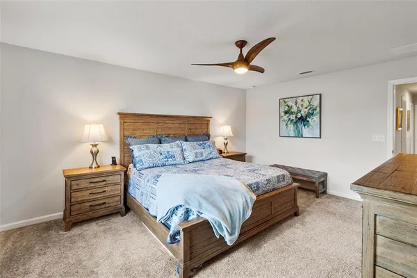a bedroom with a bed a dresser and a window