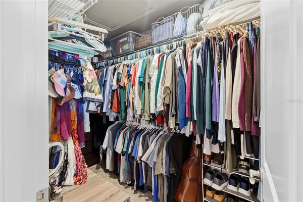 a view of walk in closet with clothes